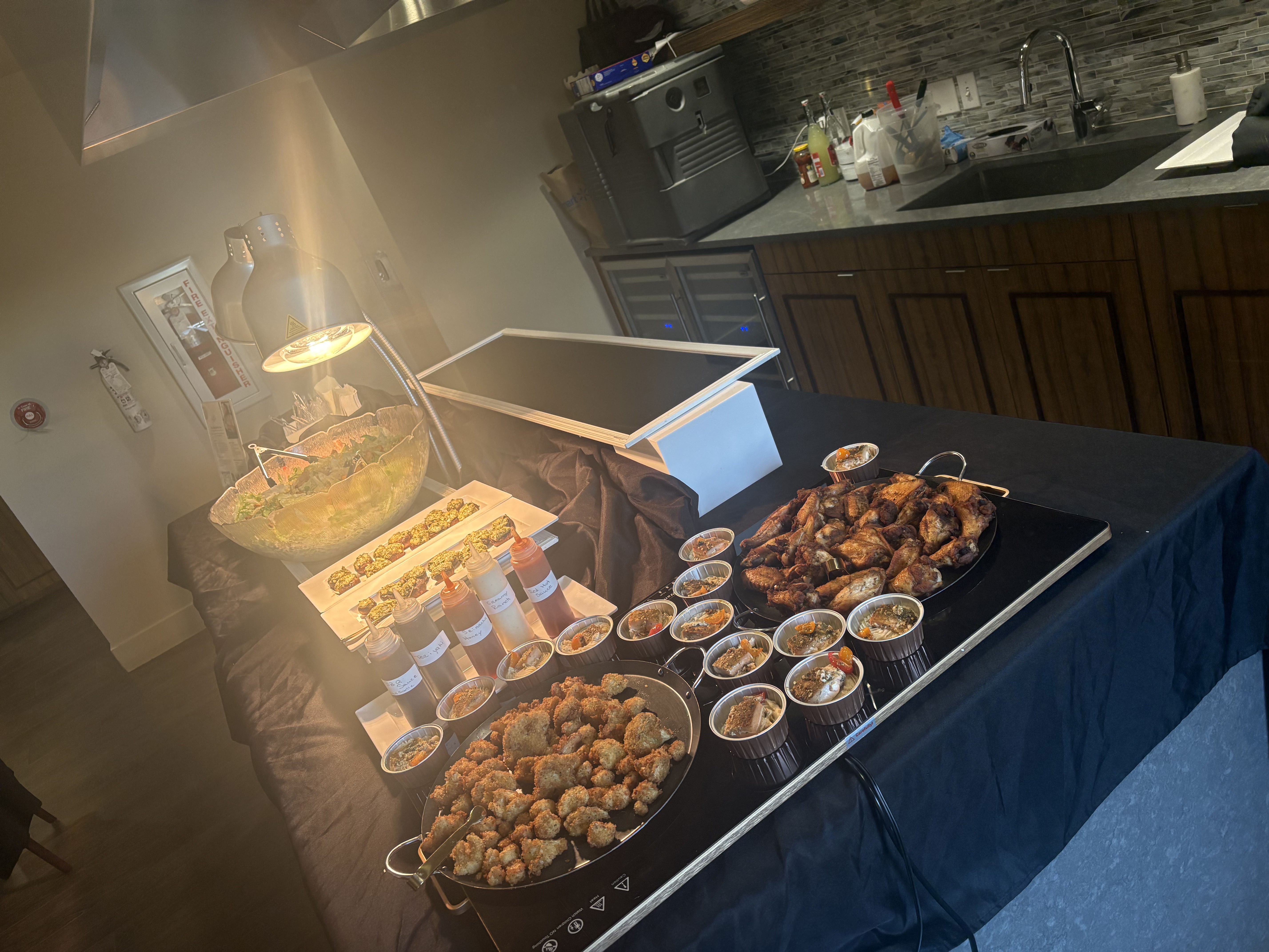 Professional catering station with appetizers and wings